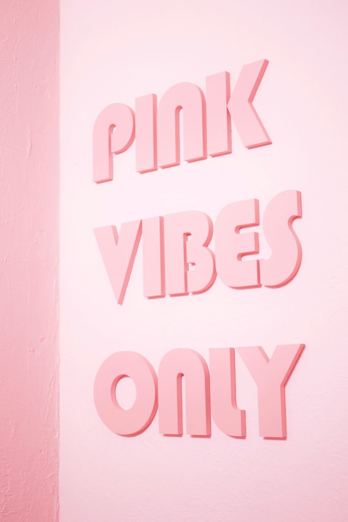 Photo of a pink wall with the words "Pink Vibes Only" from unsplash - 20th birthday ideas